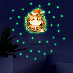 Luminous wall stickers set showing a cartoon cat in a Christmas wreath glowing in the dark