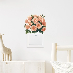Close-up of self-adhesive floral wall stickers with pink roses above a light switch