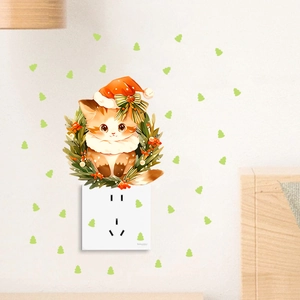Detail of Christmas cat wreath wall decal around light switch with mini tree stickers