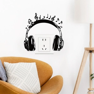 Detail of creative headphone music wall sticker in black PVC around a light switch
