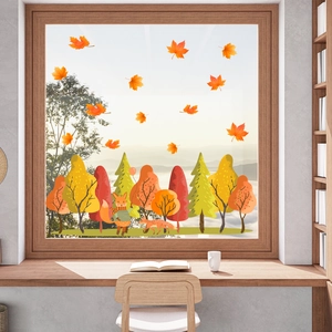 Detailed view of autumn window clings featuring cute foxes and colorful forest maple leaves