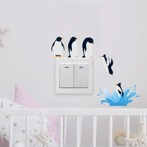 Cartoon penguin wall stickers for light switch decoration in a cozy nursery room setting