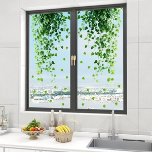Fresh green leaf static window stickers for home decor on clear glass surface