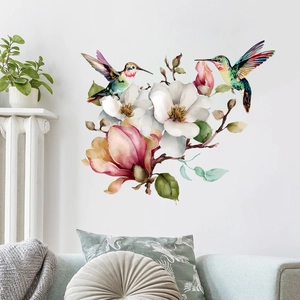 Sticker mural aquarelle avec colibris et fleurs de magnolia au-dessus d'un canapé vert