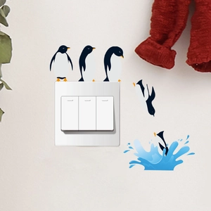 Detail of creative penguin diving wall stickers on a light wall for 3-gang switch decor
