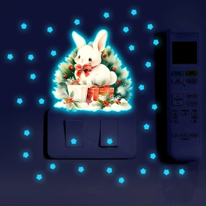 Luminous wall sticker set showing glowing rabbit and stars in a dark bedroom environment