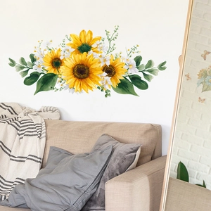 Detailed wall sticker showing watercolor yellow sunflowers and green leaves over a beige sofa