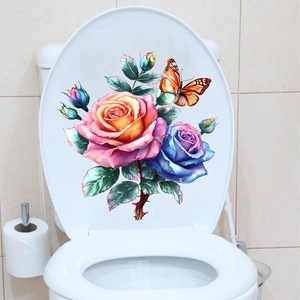 Detailed view of floral toilet sticker with pink and blue roses and an orange butterfly
