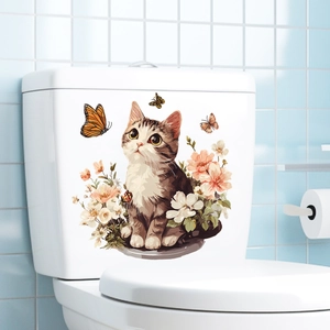 Detail of cute cat and floral sticker on white toilet tank against blue tile wall