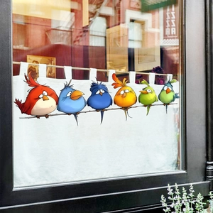 Detail of colorful cartoon birds window stickers on glass with a branch and 6 diverse birds