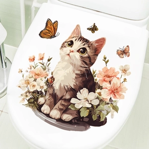 Detail view of cute cat with flowers and butterflies sticker on white toilet lid