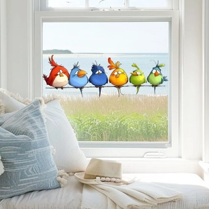Detail of colorful cartoon birds window static stickers on glass with a beach background