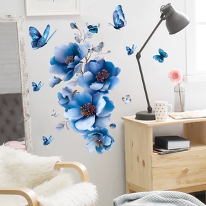 Detail view of blue floral and butterfly wall stickers in a cozy home interior setting