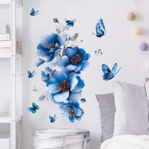 Detail of blue floral and butterfly wall decals on a clean white background