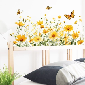 Detail of yellow wildflower wall decals with butterflies in a minimalist bedroom setting