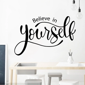 Detail showing 'Believe in yourself' wall sticker in a modern Nordic office space