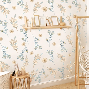 Detail of self-adhesive floral wallpaper with light blue and brown leaves in a bedroom