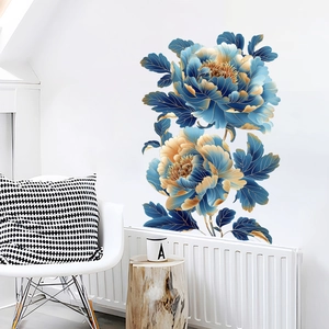 Detail view of blue and gold peony wall decals in a modern living room setting