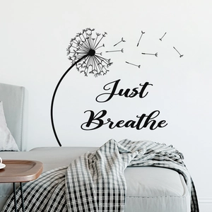 Detail showing dandelion wall decal with 'Just Breathe' text in a modern bedroom