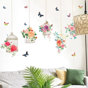 Detailed view of floral birdcage wall decals and colorful butterflies on white living room wall