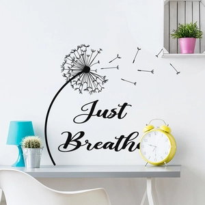 Close-up of dandelion wall sticker and Just Breathe quote in minimalist interior