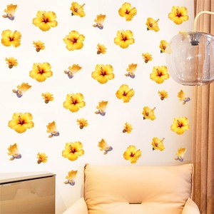 Yellow hibiscus flower wall sticker set for home decor on a white living room wall