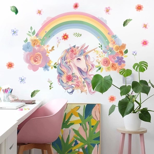 Detail of cartoon unicorn wall decals with rainbow and floral elements in kid's room