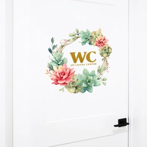 Floral wreath wall decal with WC sign and succulents on a white interior door