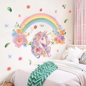 Close-up of watercolor unicorn and rainbow wall decals in a cozy children's bedroom setting