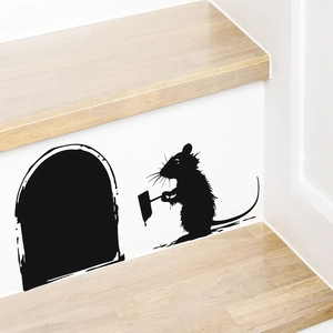 Detailed view of a black mouse hole wall sticker on a light wood staircase step