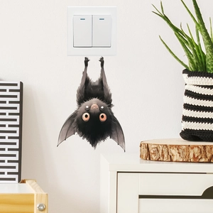 Detailed view of a cute black cartoon bat PVC wall sticker on a white surface