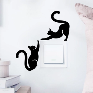 Detailed view of black cat silhouette wall stickers decorating a white light switch