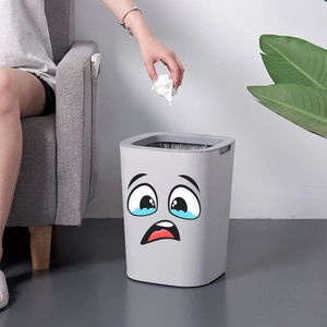 Funny crying face emoji decal on a light grey plastic garbage bin for home organization