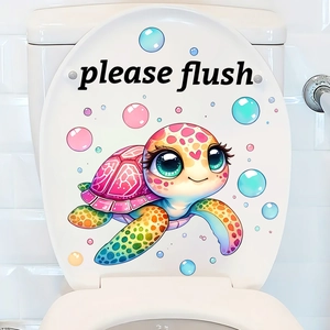 Close-up of cute cartoon sea turtle sticker with please flush text on white toilet lid