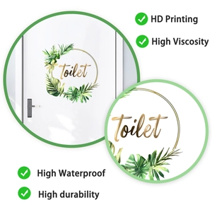 Detail of round waterproof toilet door sticker with green leaves and gold lettering