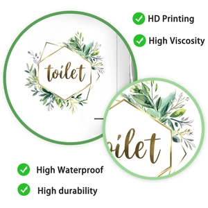 Detail of round waterproof toilet decal with green leaves and gold hexagon frame