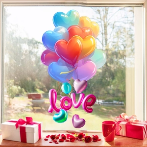 Detail of multi-colored heart balloons and love stickers on a sunlit window