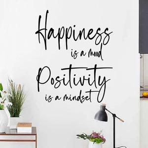 Detail of Happiness is a mood quote wall decal in black cursive on a white bedroom wall