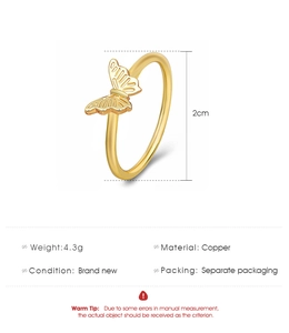 Detailed view of a golden butterfly ring made of copper with 2cm dimensions and 4.3g weight