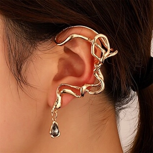 Close-up of golden irregular wave ear wrap with black teardrop crystal pendant