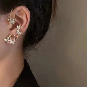 Detailed view of elegant gold butterfly ear cuff climbers with shimmering crystals
