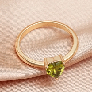Elegant rose gold ring with heart-cut olive green gemstone on pink silk background