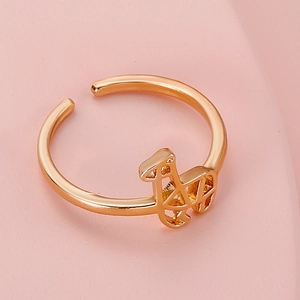 Macro detail of a geometric open toe ring in polished gold finish for women