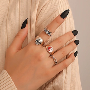 Gothic retro ring set featuring skull and spider motifs on model hand with black nails