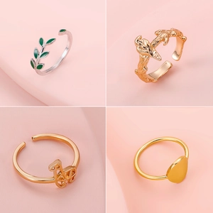 Set of four vintage geometric adjustable rings including leaf and textured designs