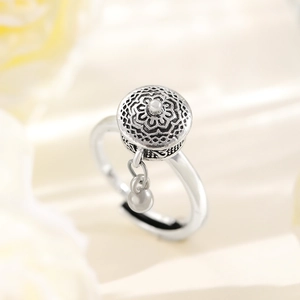Macro shot of rotatable vintage silver ring with Tibetan style prayer cylinder charm
