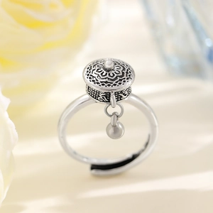 Macro detail of vintage silver spinning prayer wheel ring with white pearl accent