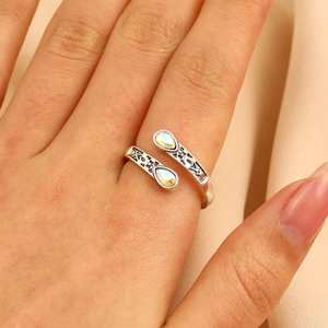 Detailed close-up of a vintage silver heart ring with sparkling teardrop stones
