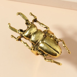 Detailed top view of a creative gold beetle ring with intricate insect textures