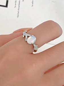 Macro shot of silver coral texture ring with oval moonstone on fashion magazine background